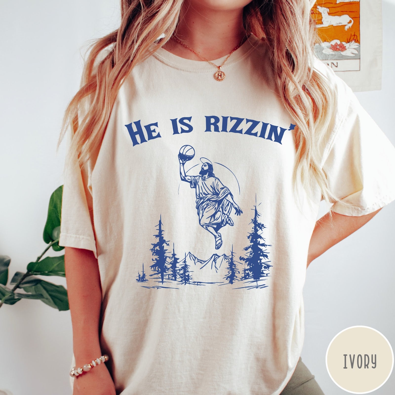 Comfort Colors tee in Ivory featuring graphic style Jesus playing basketball with mountains and pine trees illustration