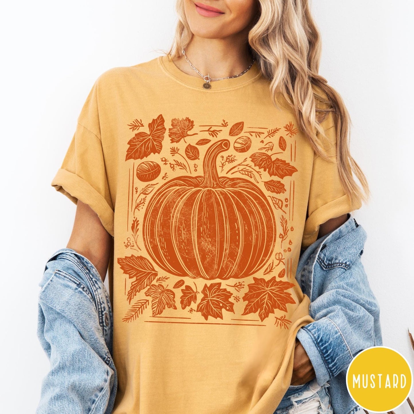 Comfort Colors tee in Mustard featuring rustic pumpkin design with surrounding fall leaves and woodland elements