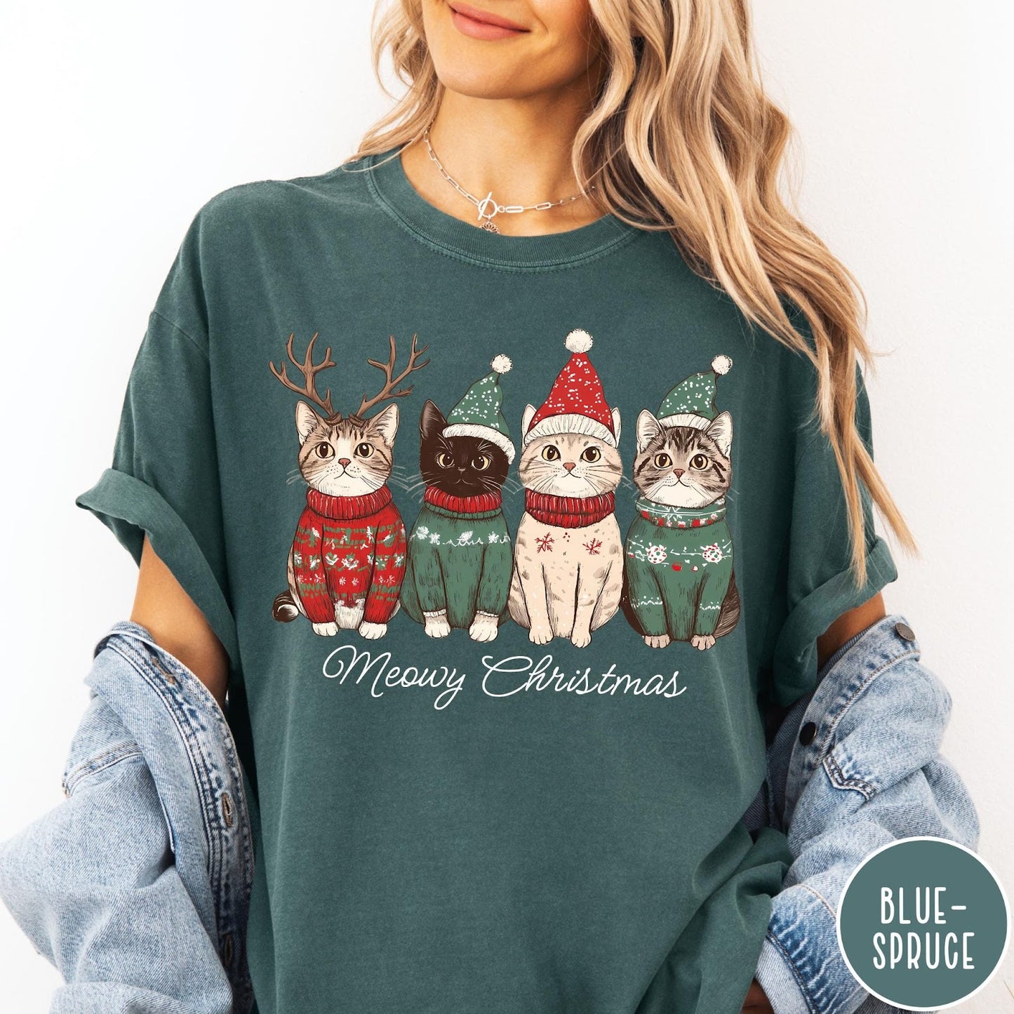Comfort Colors tee in Blue Spruce featuring holiday graphic of four cats wearing Christmas sweaters and hats