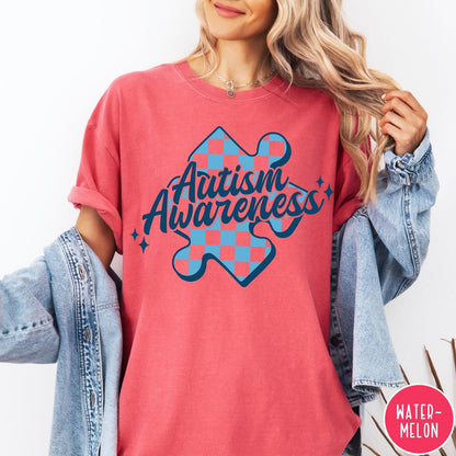 Comfort Colors tee in Watermelon featuring screen print style Autism Awareness puzzle piece with blue checkerboard pattern