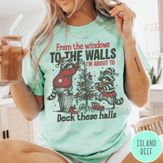 Comfort Colors tee in Island Reef featuring festive raccoon graphic with holiday lights and Christmas tree design.
