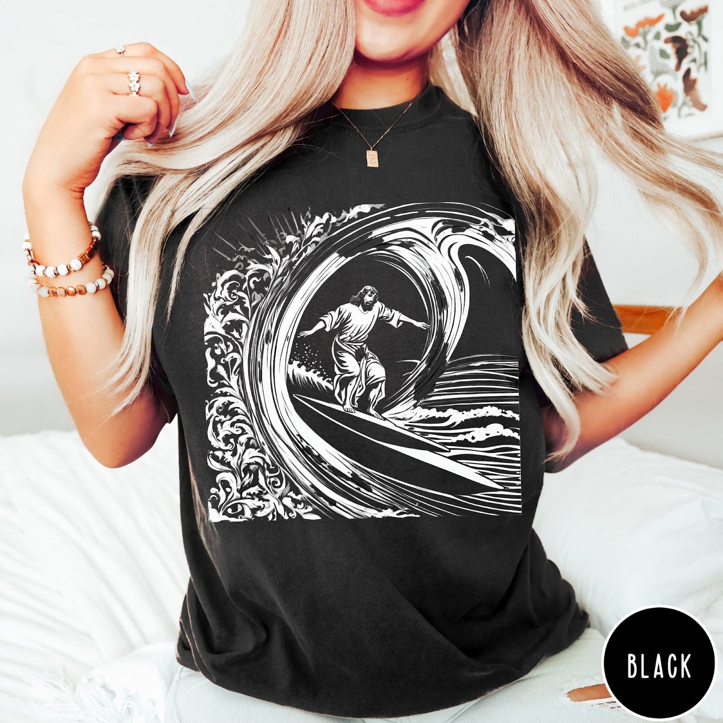 Comfort Colors tee in Black featuring graphic style Jesus surfing on a large ocean wave