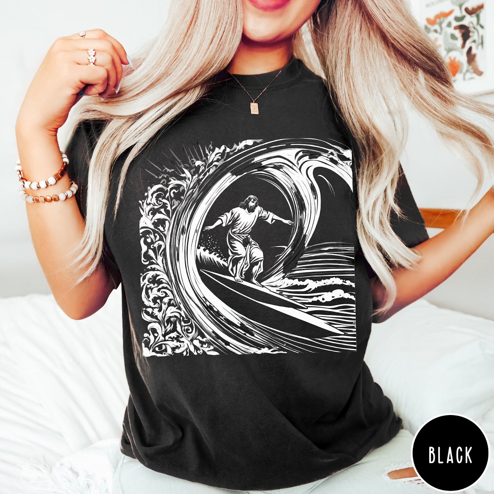 Comfort Colors tee in Black featuring graphic style Jesus surfing on a large ocean wave