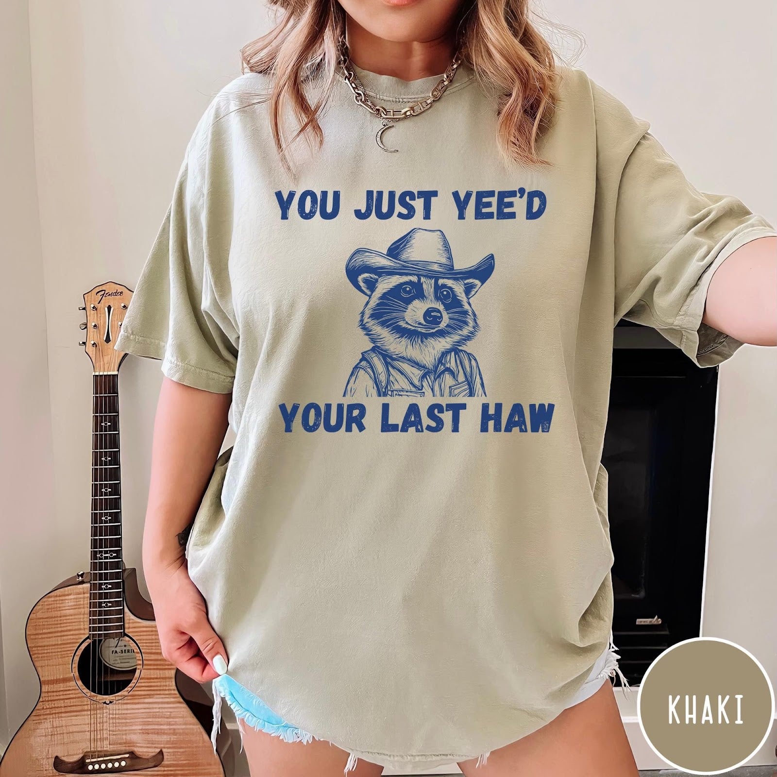 Comfort Colors tee in Khaki featuring western style graphic of a raccoon wearing a cowboy hat