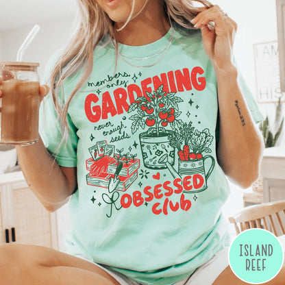 Comfort Colors tee in Island Reef featuring retro graphic gardening design with tomato plant, seeds, and gardening tools