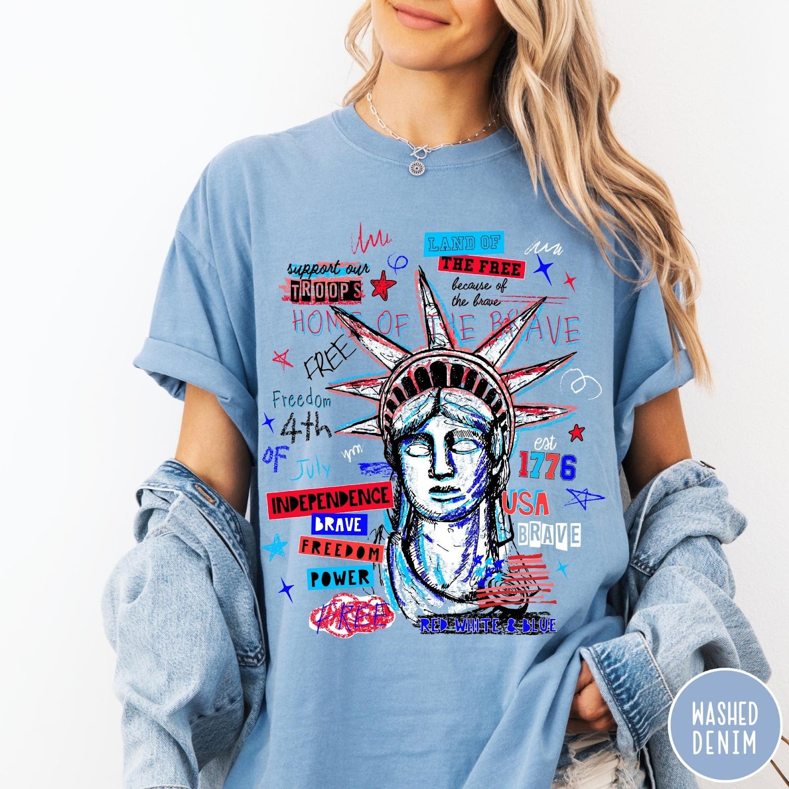 Comfort Colors tee in Washed Denim featuring grunge style Statue of Liberty graphic with patriotic red and blue text