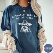 Comfort Colors tee in Midnight featuring western style graphic of a raccoon wearing a cowboy hat