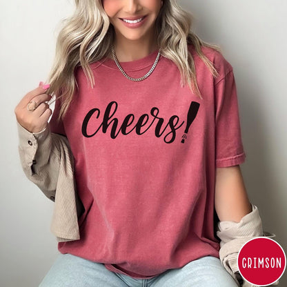 Comfort Colors tee in Crimson featuring New Year celebration graphic with black cheers text and champagne bottle