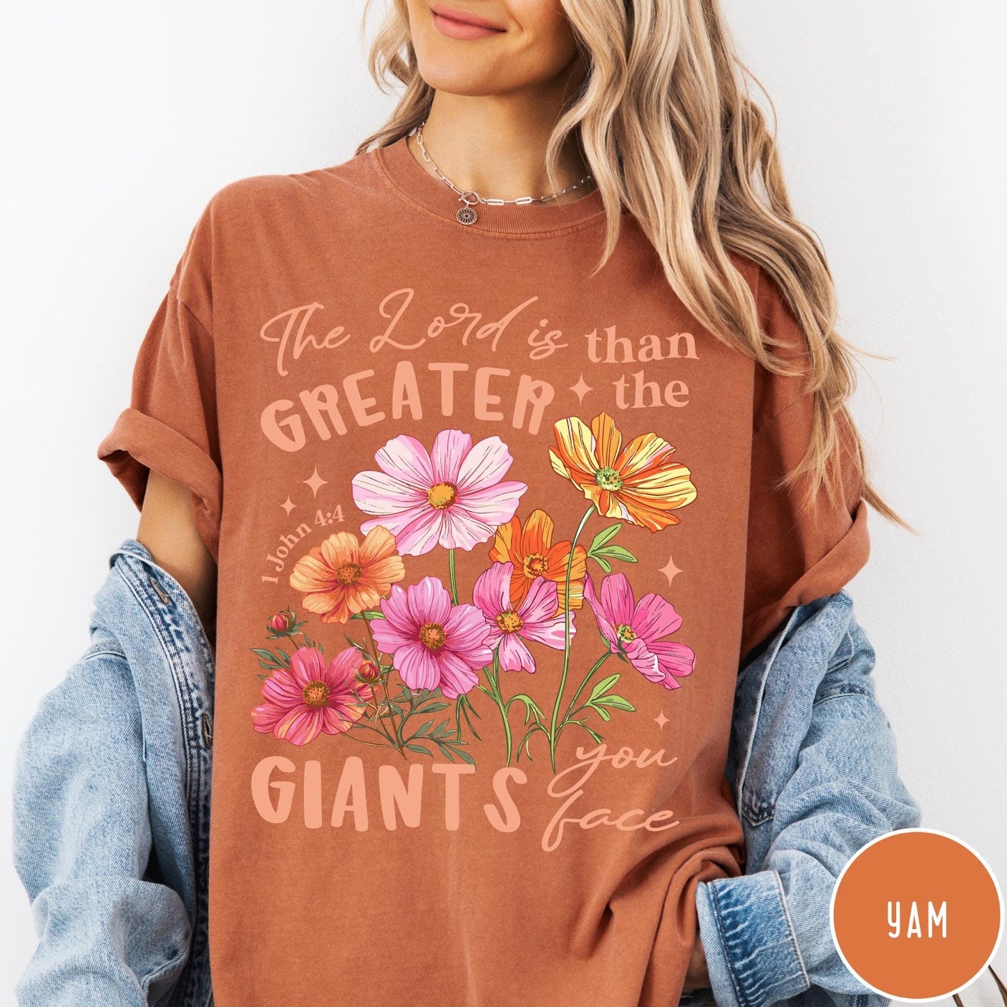 Comfort Colors tee in Yam featuring floral graphic design with Bible verse The Lord is Greater text