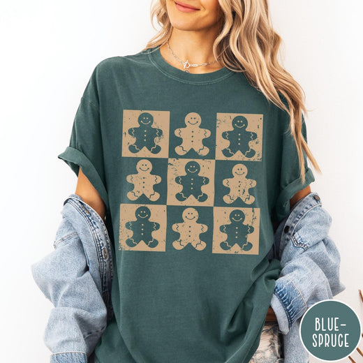 Comfort Colors tee in Blue Spruce featuring a grid design of nine distressed gingerbread cookie graphic illustrations