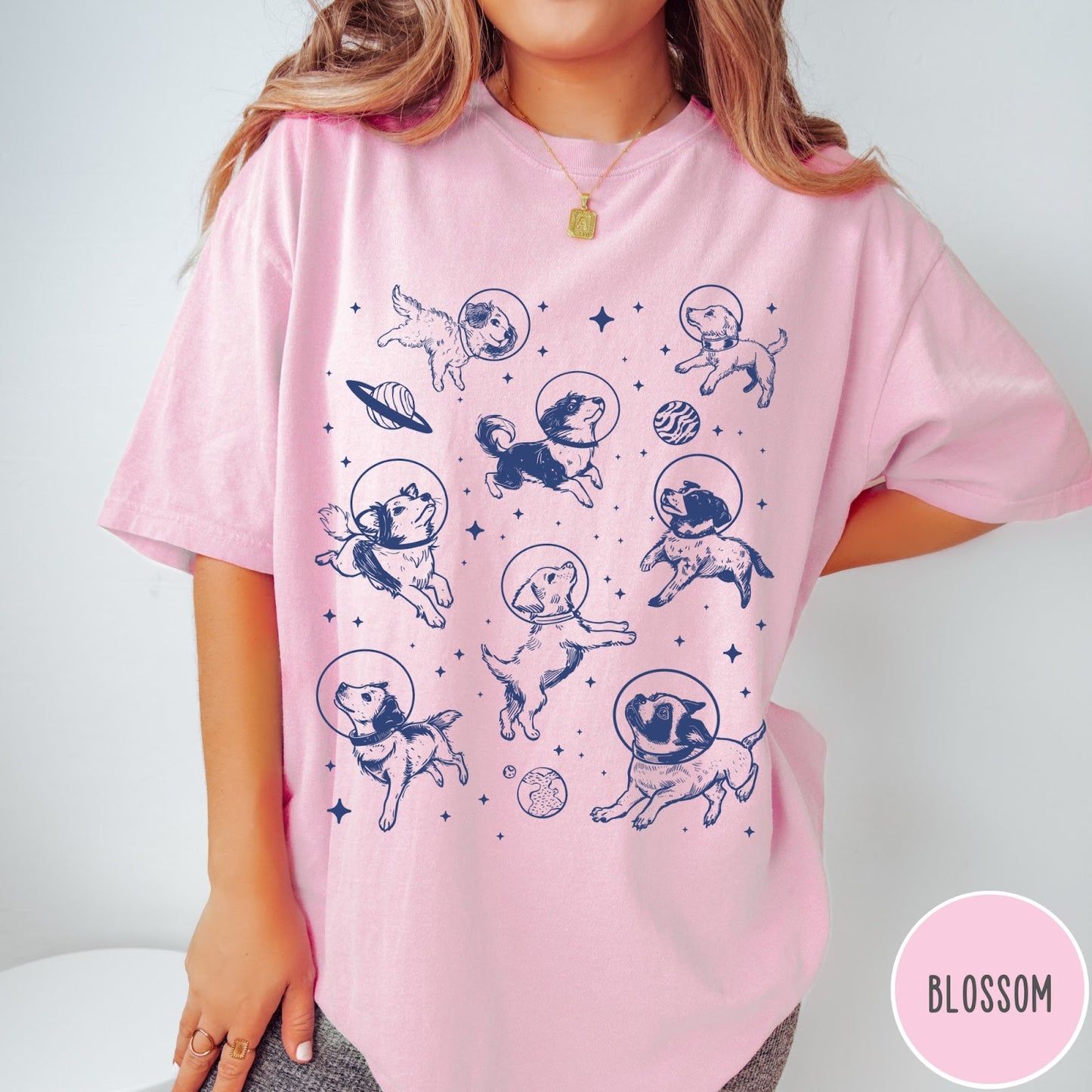 Comfort Colors tee in Blossom featuring space theme graphic with various dogs wearing astronaut helmets and planets