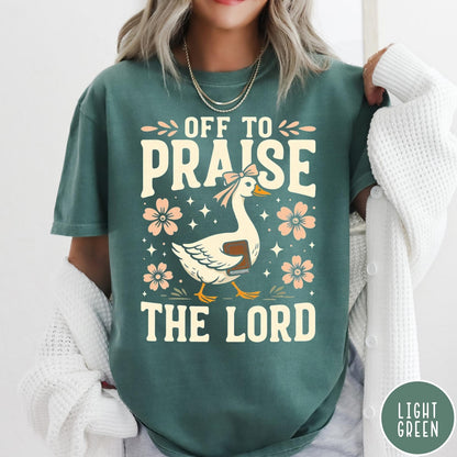 Comfort Colors tee in Light Green featuring retro style graphic of a goose wearing a bow holding a book