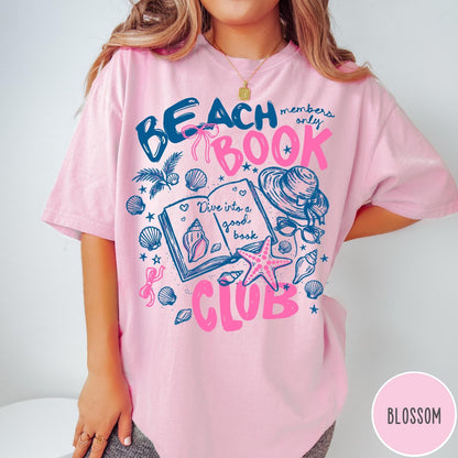 Comfort Colors tee in Blossom featuring beach book club graphic with open book, shells, and hat