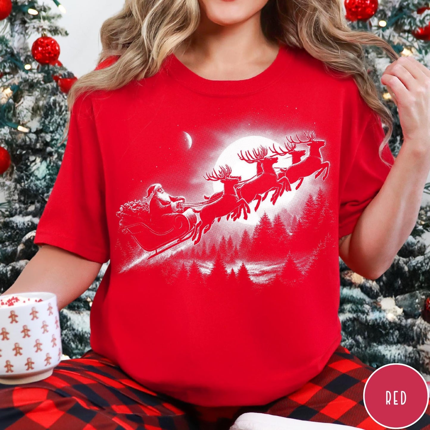 Comfort Colors tee in Red featuring vintage style Santa Claus flying in a sleigh with reindeer