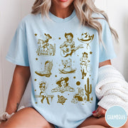Comfort Colors tee in Chambray featuring retro western collage graphic with cowgirls, boots, and desert elements