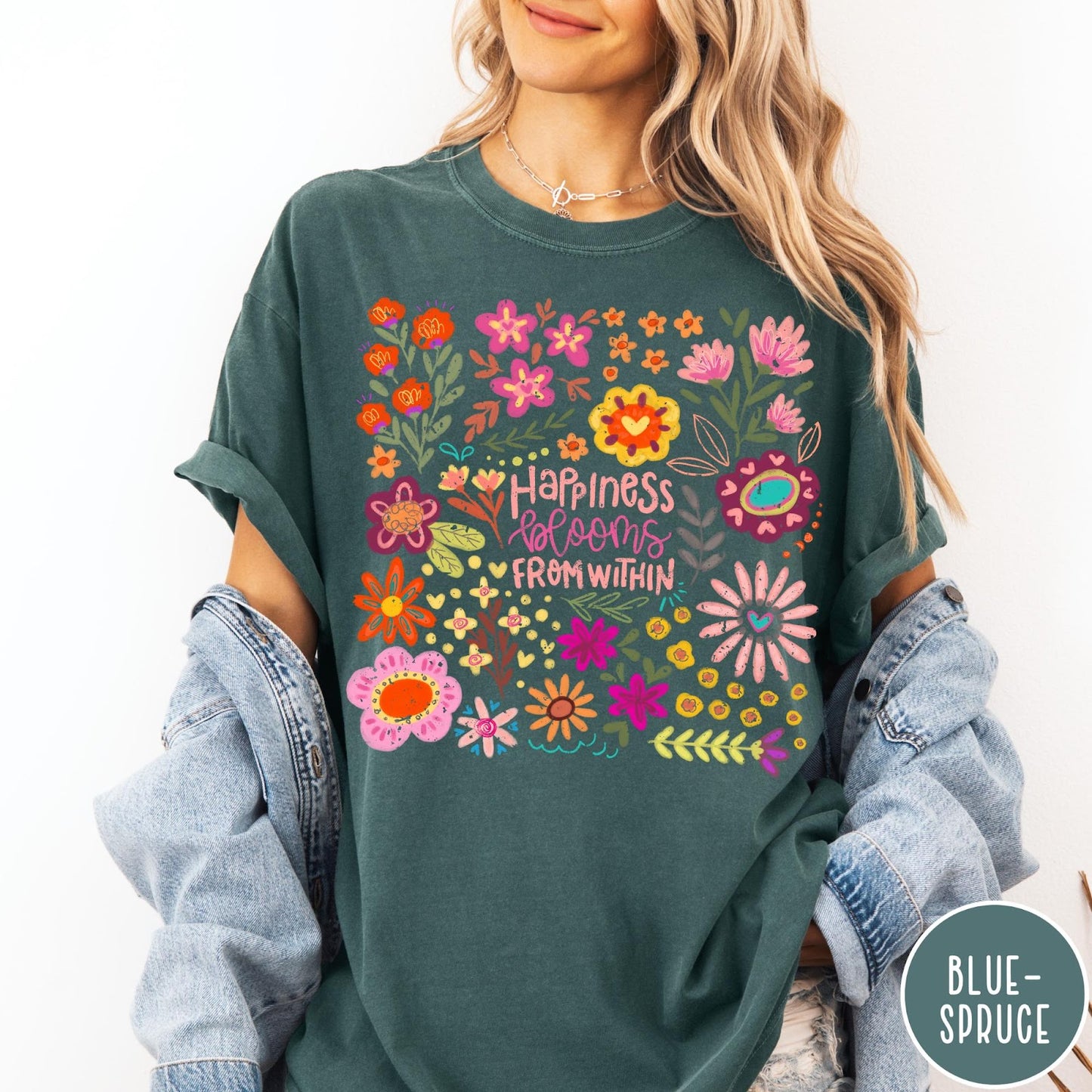 Comfort Colors tee in Blue Spruce featuring floral wildflowers design with Happiness Blooms Within text graphic description