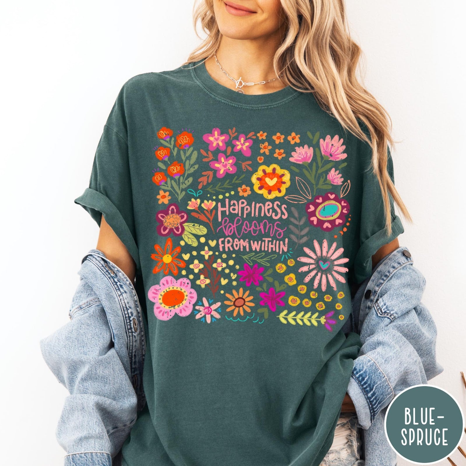 Comfort Colors tee in Blue Spruce featuring floral wildflowers design with Happiness Blooms Within text graphic description