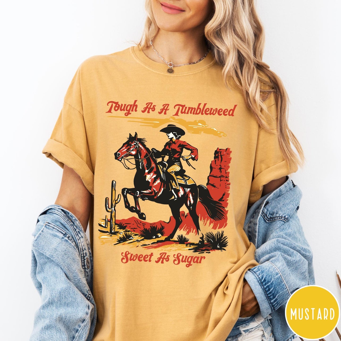 Comfort Colors tee in Mustard featuring western style graphic of a cowgirl riding a horse in desert