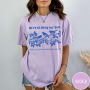 Comfort Colors tee in Orchid featuring graphic illustration of birds on a branch with text.