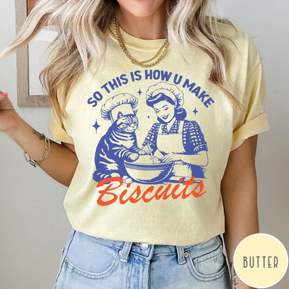Comfort Colors tee in Butter featuring vintage style graphic of a woman and cat baking biscuits together