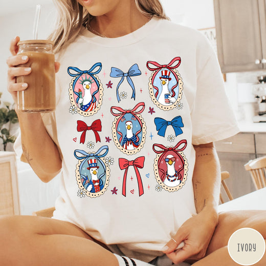 Comfort Colors tee in Ivory featuring coquette style patriotic goose graphic with bows and floral accents