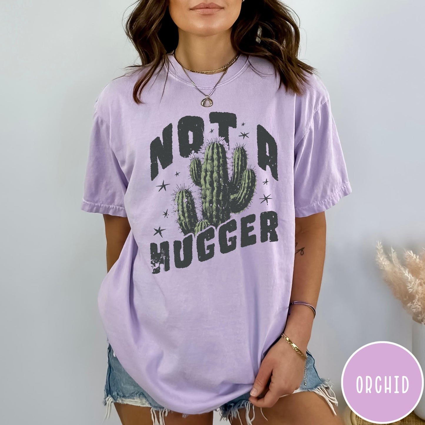 Comfort Colors tee in Orchid featuring cactus graphic and Not a Hugger text with small stars