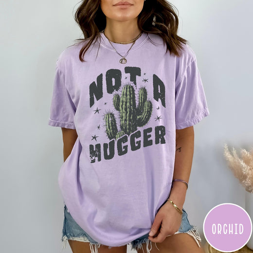 Comfort Colors tee in Orchid featuring cactus graphic and Not a Hugger text with small stars