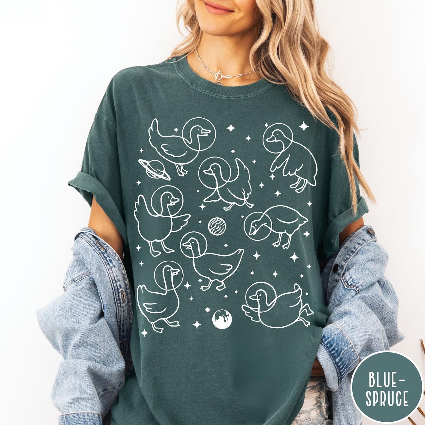 Comfort Colors tee in Blue Spruce featuring line art graphic of multiple geese wearing astronaut helmets in space