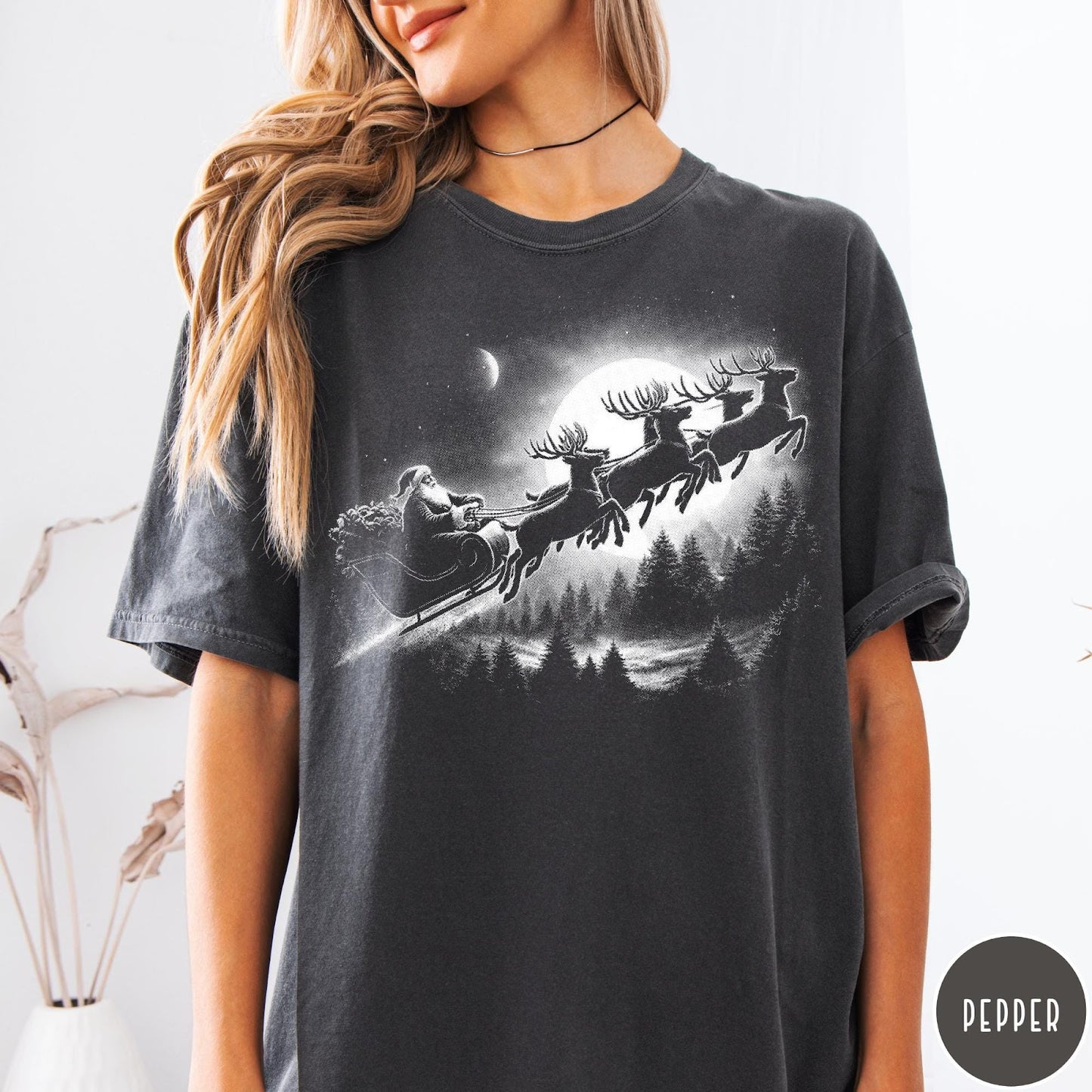 Comfort Colors tee in Pepper featuring vintage style graphic of Santa Claus flying his sleigh with reindeer