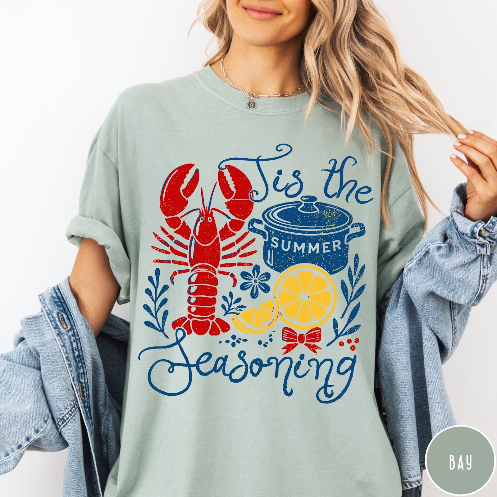 Comfort Colors tee in Bay featuring lobster boil graphic with a lobster, cooking pot, and lemon slices.