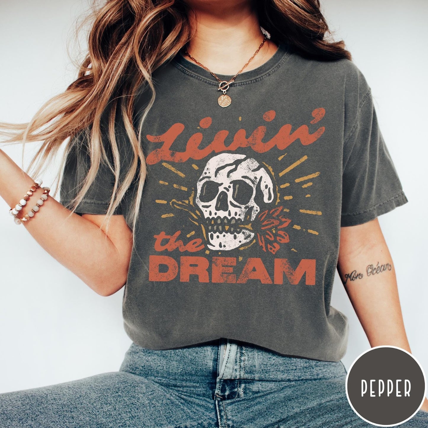 Comfort Colors tee in Pepper featuring vintage style skull graphic with Livin the Dream text design