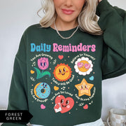 Comfort Colors tee in Forest Green featuring retro mascot design with daily affirmations and colorful graphics