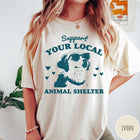 Comfort Colors tee in Ivory featuring graphic illustration of a dog wearing sunglasses and surrounding small hearts