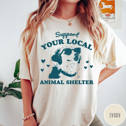 Comfort Colors tee in Ivory featuring graphic illustration of a dog wearing sunglasses and surrounding small hearts