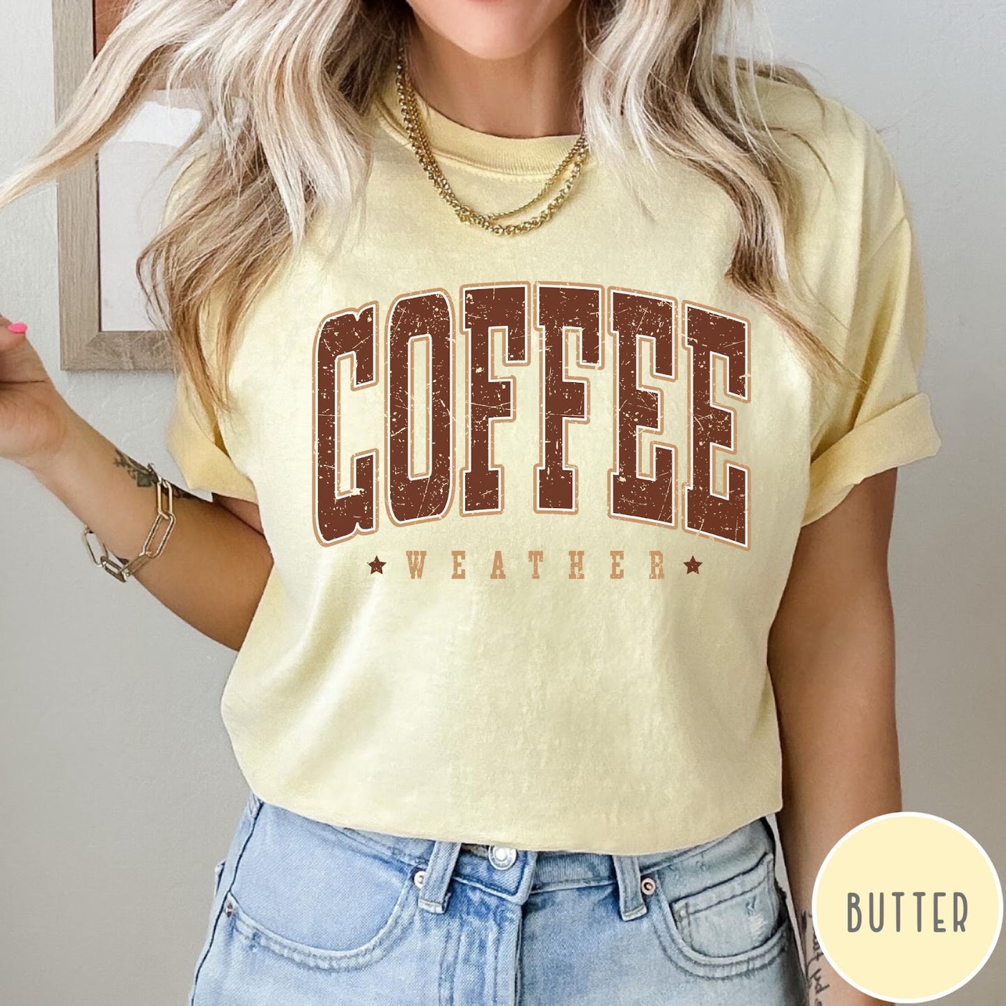 Comfort Colors tee in Butter featuring collegiate style Coffee Weather graphic with distressed brown text and stars