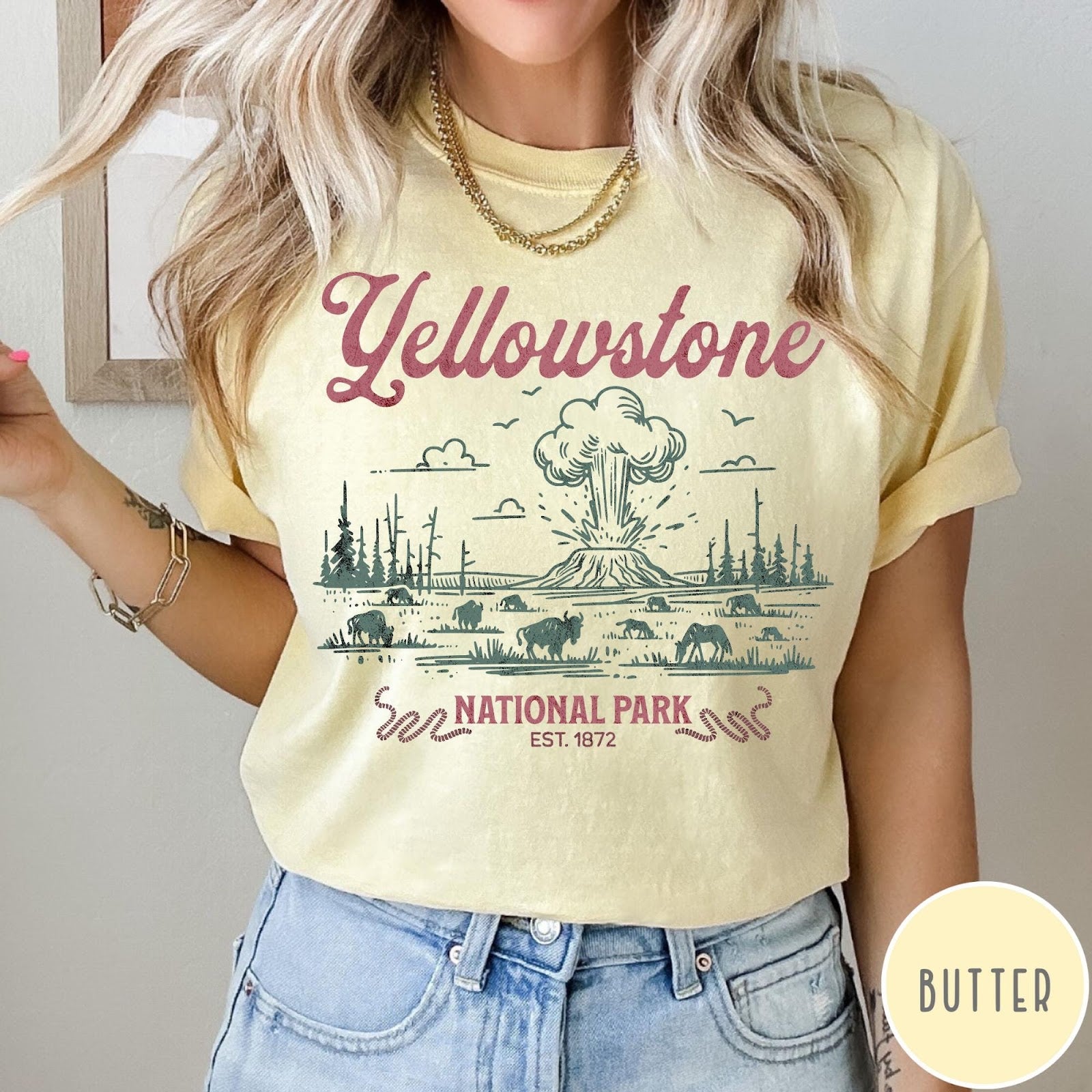 Comfort Colors tee in Butter featuring retro graphic design of Yellowstone National Park with bison and geyser