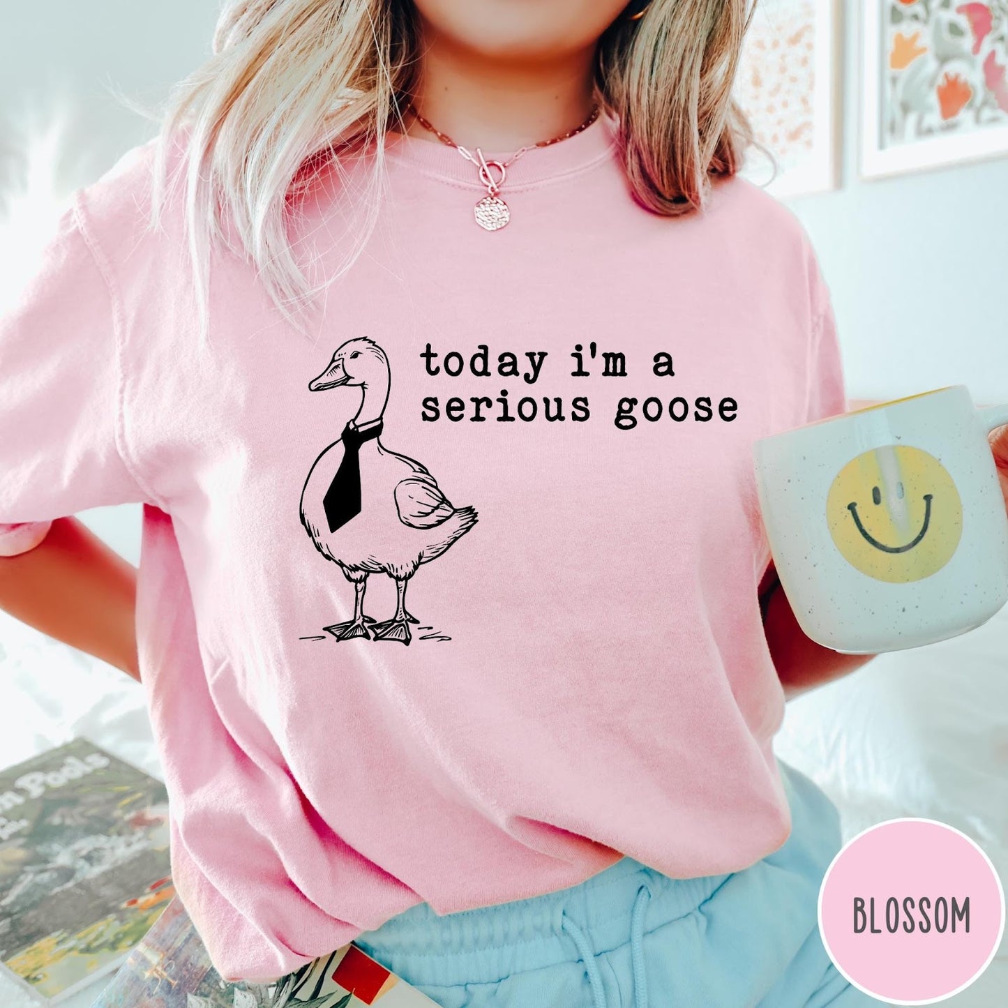 Comfort Colors tee in Blossom featuring minimalist graphic design of a goose wearing a necktie and text