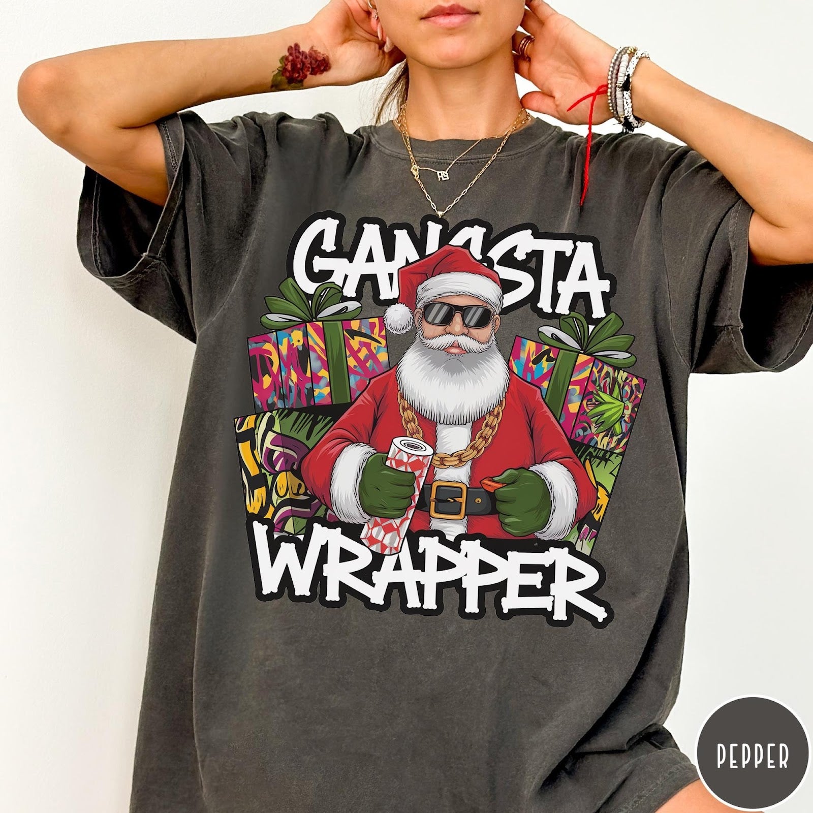 Comfort Colors tee in Pepper featuring cartoon style Santa Claus wearing sunglasses and gold chain holding wrapping paper