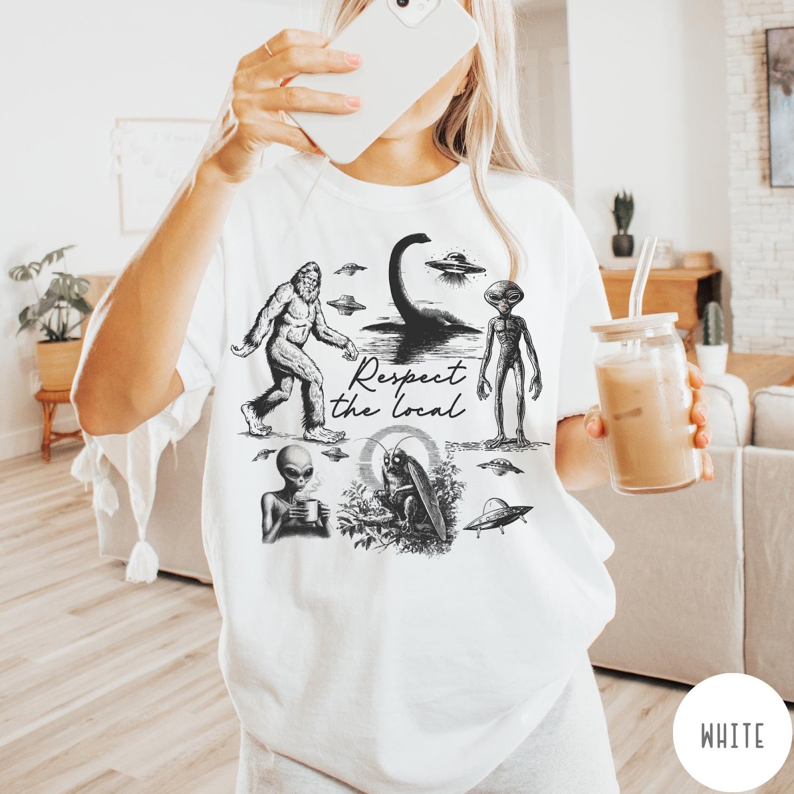 Comfort Colors tee in White featuring vintage style cryptid graphic with Bigfoot, UFOs, and alien creatures.