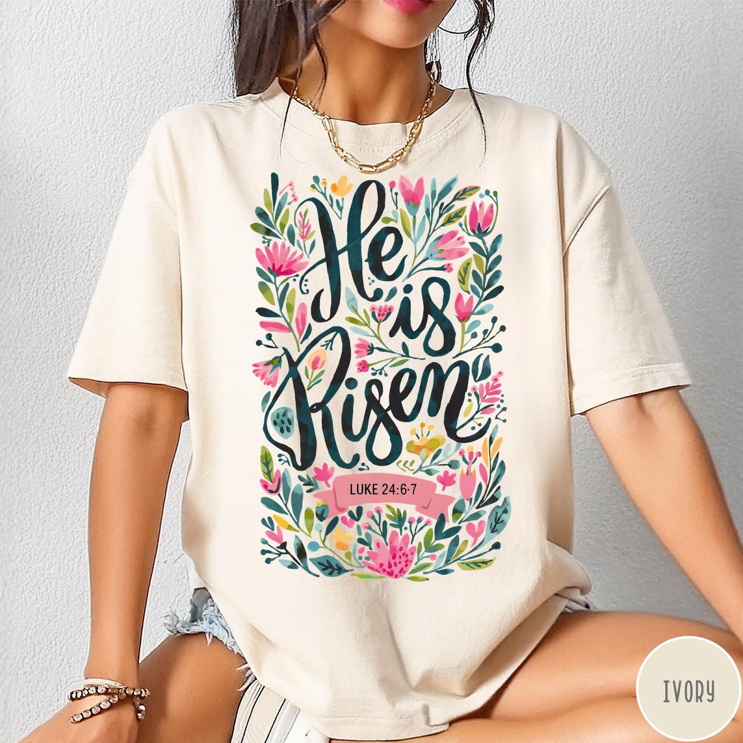 Comfort Colors tee in Ivory featuring religious floral design with He is Risen text graphic