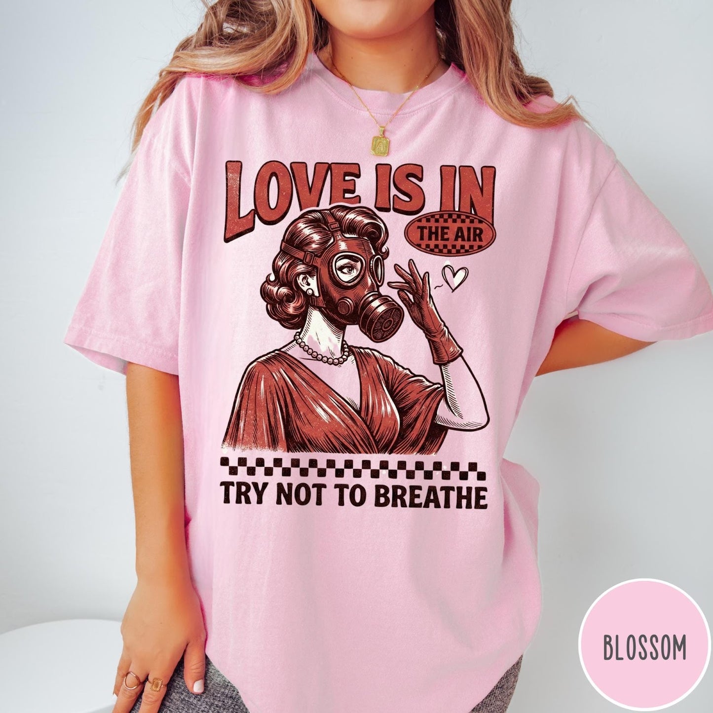 Comfort Colors tee in Blossom featuring retro graphic design of a woman wearing a gas mask