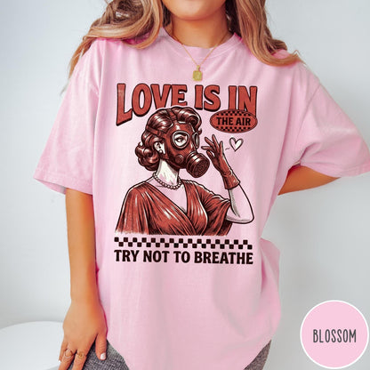 Comfort Colors tee in Blossom featuring retro graphic design of a woman wearing a gas mask