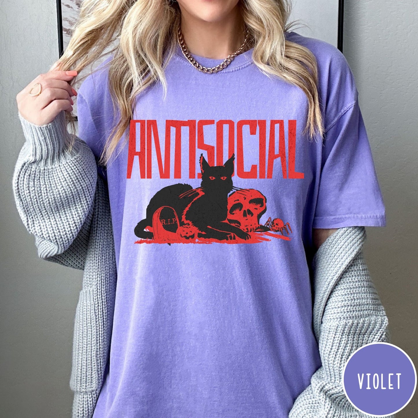 Comfort Colors tee in Violet featuring retro graphic design of a black cat with skull and tombstone