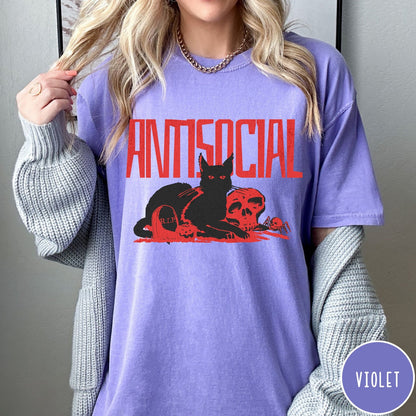 Comfort Colors tee in Violet featuring retro graphic design of a black cat with skull and tombstone