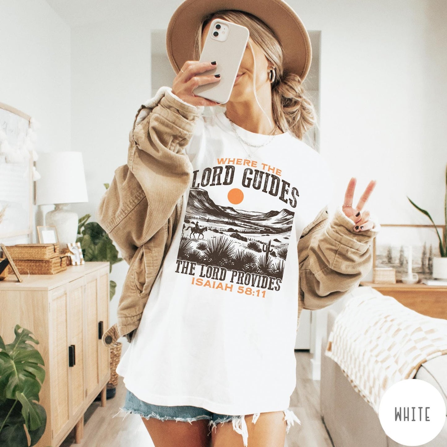 Comfort Colors tee in White featuring desert landscape graphic with a rider and sun design.