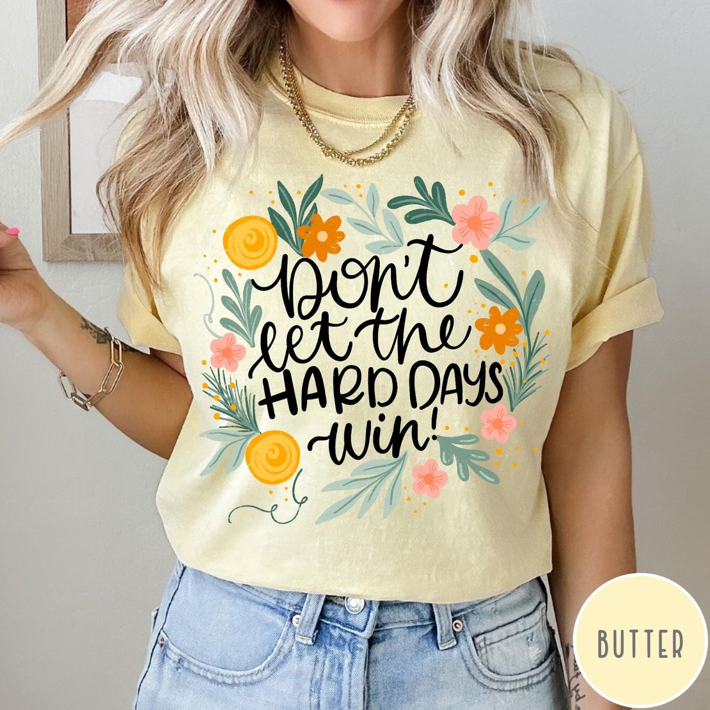 Comfort Colors tee in Butter featuring floral mental health encouragement graphic with the text Don't Let The Hard Days Win