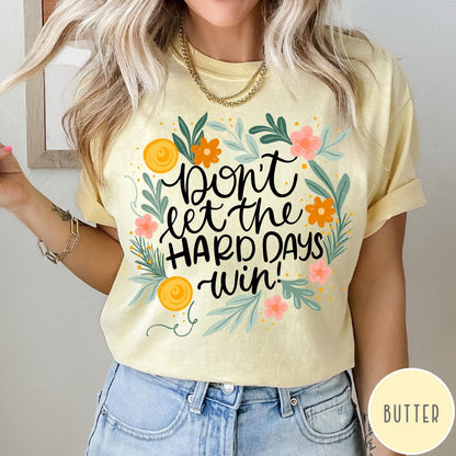 Comfort Colors tee in Butter featuring floral mental health encouragement graphic with the text Don't Let The Hard Days Win