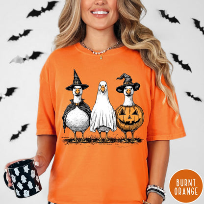 Comfort Colors tee in Burnt Orange featuring Halloween graphic with three geese dressed as a witch, ghost, and pumpkin