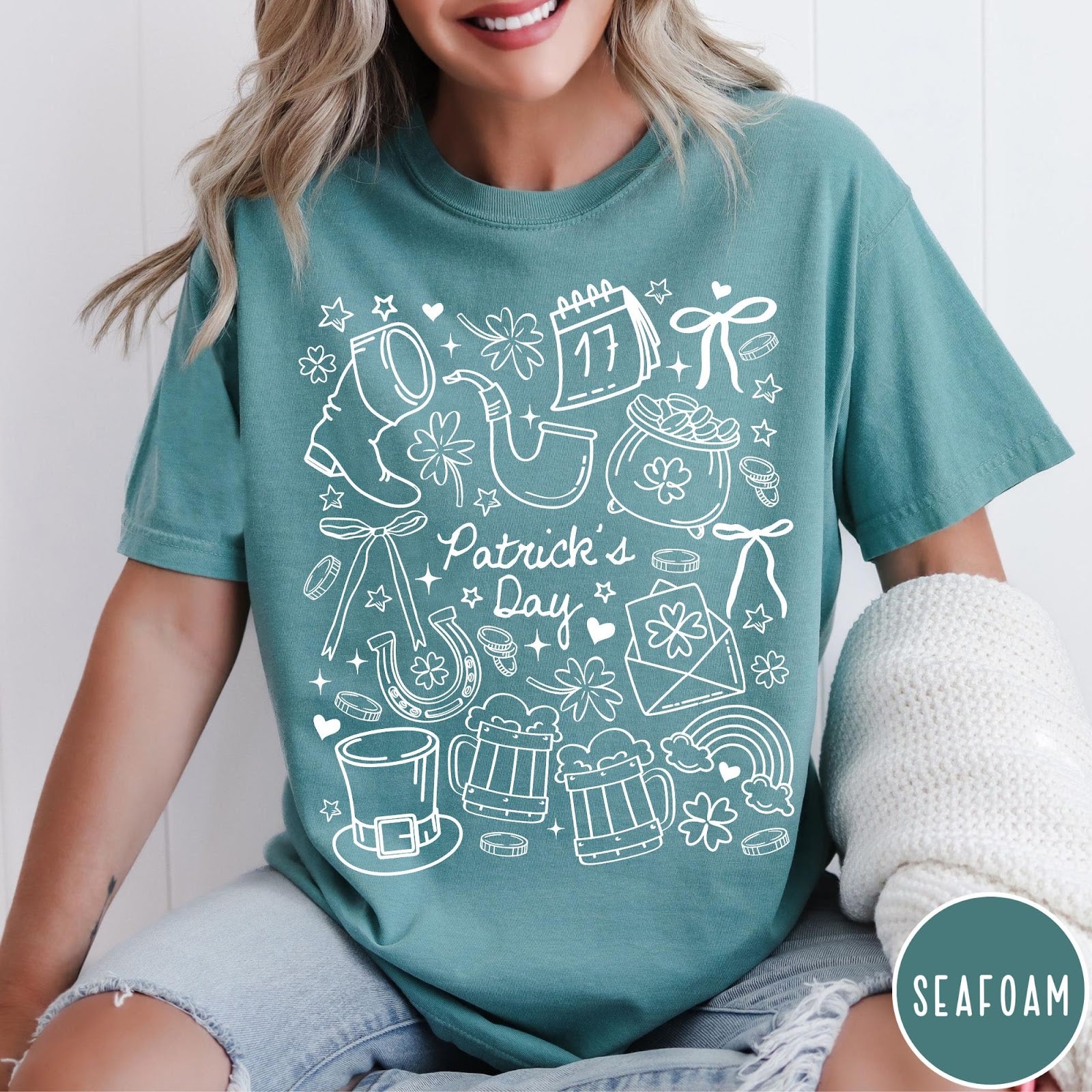 Comfort Colors tee in Seafoam featuring white line art style St. Patrick's Day icons including shamrocks and leprechaun hat