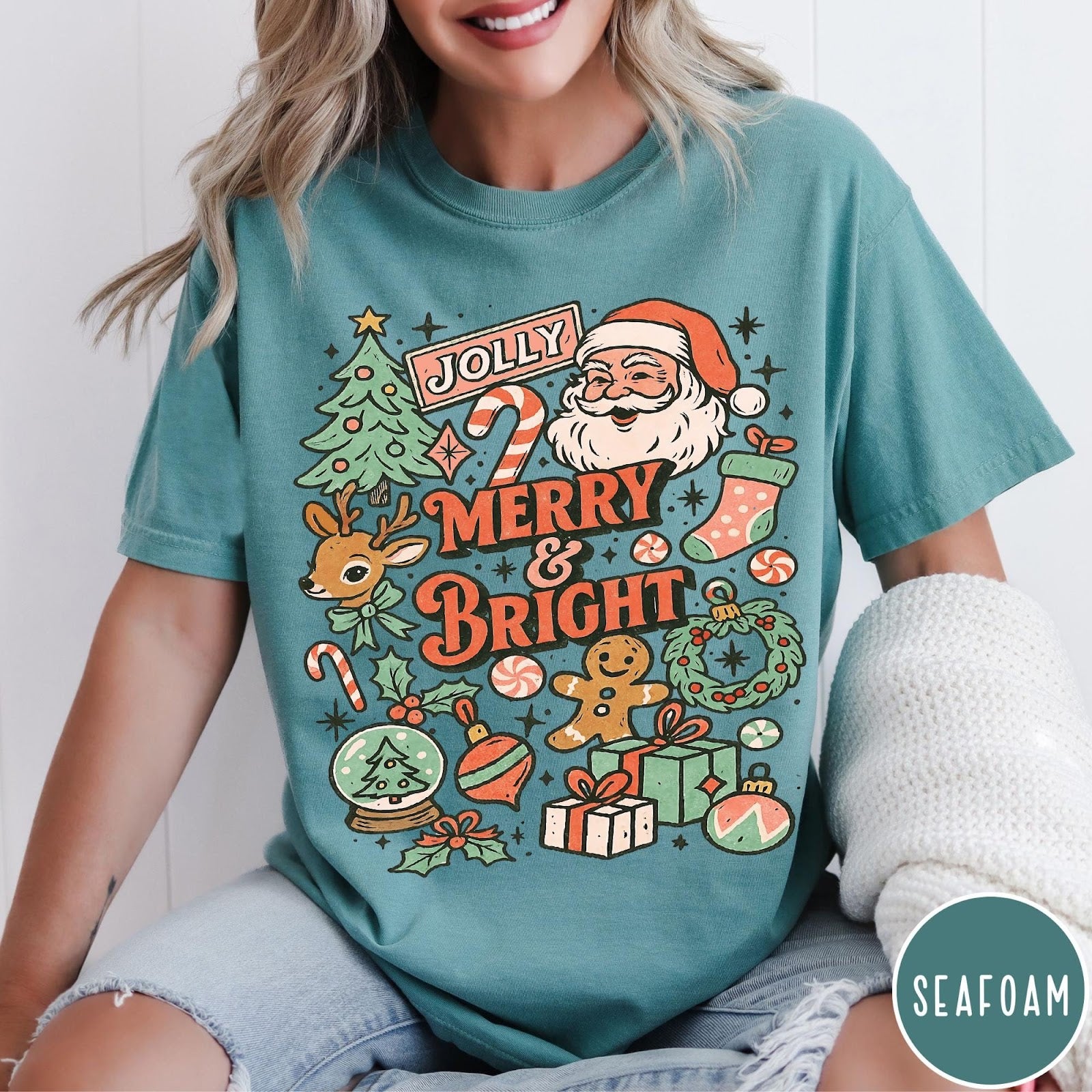 Comfort Colors tee in Seafoam featuring retro holiday design with Santa, reindeer, and Christmas icons.